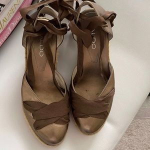 Platform sandals with an ankle wrap around ribbon. Gently worn. Dark gold.
